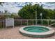 Community hot tub with surrounding brick pavers at 1660 Summerhouse Ln # 102, Sarasota, FL 34242