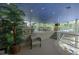 Open and airy interior with a split-level design and glass railings at 1660 Summerhouse Ln # 102, Sarasota, FL 34242