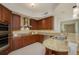 Updated kitchen featuring granite counters and wood cabinets at 1660 Summerhouse Ln # 102, Sarasota, FL 34242