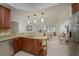 Bright, open kitchen featuring granite countertops and stainless steel appliances with an open floor plan at 1660 Summerhouse Ln # 102, Sarasota, FL 34242