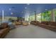 Community lounge with comfortable seating and large windows at 1660 Summerhouse Ln # 102, Sarasota, FL 34242