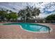 Inviting kidney-shaped pool with brick pavers and ample seating at 1660 Summerhouse Ln # 102, Sarasota, FL 34242