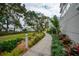 Landscaped walkway with lush greenery leading to the waterfront at 1660 Summerhouse Ln # 102, Sarasota, FL 34242