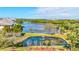 Aerial view of waterfront community with lush landscaping and pond at 10037 62Nd N Ter # 23, St Petersburg, FL 33708