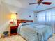 Spacious bedroom with double bed, nightstand, and ceiling fan at 10037 62Nd N Ter # 23, St Petersburg, FL 33708