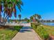 Concrete walkway leading to a community pool and lake at 10037 62Nd N Ter # 23, St Petersburg, FL 33708