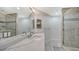 Double vanity bathroom with a walk in shower at 611 Riviera Dunes Way # 702, Palmetto, FL 34221