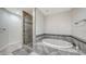 Spa-like bathroom featuring a large soaking tub and glass shower at 611 Riviera Dunes Way # 702, Palmetto, FL 34221