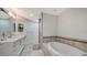 Bathroom with soaking tub and double vanity at 611 Riviera Dunes Way # 702, Palmetto, FL 34221