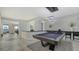 Game room with a pool table and bar seating at 611 Riviera Dunes Way # 702, Palmetto, FL 34221