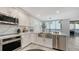 Bright kitchen with stainless steel appliances and farmhouse sink at 611 Riviera Dunes Way # 702, Palmetto, FL 34221