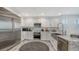 Modern kitchen with stainless steel appliances and white cabinets at 611 Riviera Dunes Way # 702, Palmetto, FL 34221