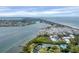 Scenic aerial view showcases the property's coastal community, tennis courts, and waterfront access at 815 Bayport Way # 815, Longboat Key, FL 34228