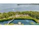 Aerial view of the waterway with mature tree growth, a dock, and a variety of colorful boats at 815 Bayport Way # 815, Longboat Key, FL 34228