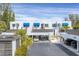 Modern white condos with carports and blue awnings exude coastal charm and offer convenient parking at 815 Bayport Way # 815, Longboat Key, FL 34228