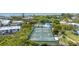 Aerial view of well-maintained tennis courts near the water and a community pool at 815 Bayport Way # 815, Longboat Key, FL 34228