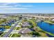 Aerial view of community with houses, lake and pool at 4211 Fairway Pl, North Port, FL 34287