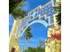 Community entrance with attractive archway and landscaping at 1305 4Th St # 201F, Sarasota, FL 34236