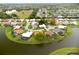 Aerial view of single story home with lake access at 1654 Waxwing Ct, Venice, FL 34293