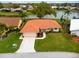 Single-story home with orange tile roof, large yard, and water view at 1654 Waxwing Ct, Venice, FL 34293