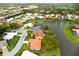 Aerial view of single story home with lake access at 1654 Waxwing Ct, Venice, FL 34293