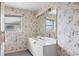 Small bathroom with floral wallpaper, a single sink vanity, and a shower/tub combo at 1654 Waxwing Ct, Venice, FL 34293