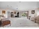 Living room with vaulted ceiling, sliding glass doors to patio, and view of golf course at 1654 Waxwing Ct, Venice, FL 34293