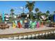 Community patio with colorful chairs and picnic tables at 2601 Gulf N Dr # 603, Bradenton Beach, FL 34217