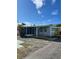 Mobile home with screened porch and gravel driveway at 2601 Gulf N Dr # 603, Bradenton Beach, FL 34217