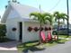 White storage shed with red chairs and flowers at 2601 Gulf N Dr # 603, Bradenton Beach, FL 34217