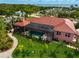 Pink house with red tile roof, pool, and canal views at 4409 Crews Ct, Port Charlotte, FL 33952