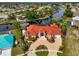 Pink house with red tile roof and landscaped yard at 4409 Crews Ct, Port Charlotte, FL 33952