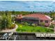 Pink house with red tile roof, pool, dock, and waterway at 4409 Crews Ct, Port Charlotte, FL 33952