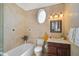 Clean bathroom with a shower/tub combo and updated vanity at 4409 Crews Ct, Port Charlotte, FL 33952