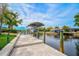 Covered boat dock with lift, offering convenient water access at 4409 Crews Ct, Port Charlotte, FL 33952