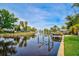 Tranquil canal-front view, featuring a private dock and lush greenery at 4409 Crews Ct, Port Charlotte, FL 33952