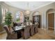 Formal dining room with large windows and elegant chandelier at 4409 Crews Ct, Port Charlotte, FL 33952