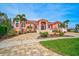 Grand waterfront home with Mediterranean styling and lush landscaping at 4409 Crews Ct, Port Charlotte, FL 33952