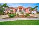 Grand waterfront home with Mediterranean styling and lush landscaping at 4409 Crews Ct, Port Charlotte, FL 33952