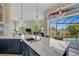 Modern kitchen with marble countertops and a view of the pool at 4409 Crews Ct, Port Charlotte, FL 33952