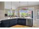 Modern kitchen with marble countertops and a view of the pool at 4409 Crews Ct, Port Charlotte, FL 33952