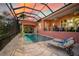 Inviting pool and spa area with covered lanai and lounge chairs at 4409 Crews Ct, Port Charlotte, FL 33952