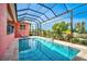 Relaxing pool and screened enclosure with lounge chairs at 4409 Crews Ct, Port Charlotte, FL 33952