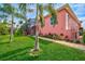 Landscaped side yard with walkway to the pool at 4409 Crews Ct, Port Charlotte, FL 33952