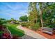 Landscaped waterfront pathway with a bench overlooking the canal at 4409 Crews Ct, Port Charlotte, FL 33952