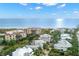 Overhead shot of luxurious coastal homes nestled amongst mature trees near the water at 5005 Gulf Of Mexico Dr # 5, Longboat Key, FL 34228