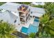 Aerial view of a home with a pool, spa, and multiple balconies at 5005 Gulf Of Mexico Dr # 5, Longboat Key, FL 34228