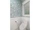 Charming powder room with flamingo wallpaper, modern toilet, and white wainscoting at 5005 Gulf Of Mexico Dr # 5, Longboat Key, FL 34228