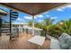 Outdoor deck with views of the tropical landscaping and a spiral staircase leading to lower levels at 5005 Gulf Of Mexico Dr # 5, Longboat Key, FL 34228