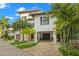 Elegant two-story home with manicured landscaping and a brick driveway at 5005 Gulf Of Mexico Dr # 5, Longboat Key, FL 34228